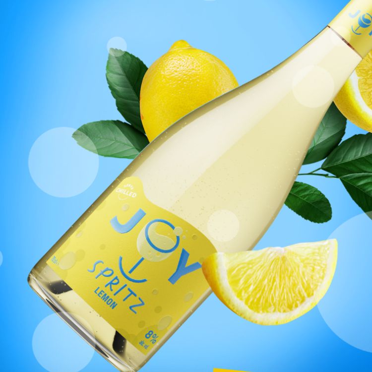 A bottle of JOY Lemon Spritz with a blue background and lemons.